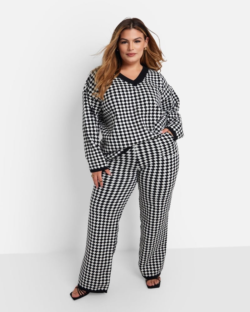 Front of a model wearing a size 1X Octavia Checkered Knit Wide Leg Pants W. Pockets - Black & White in Multicolor by Rebdolls. | dia_product_style_image_id:321654